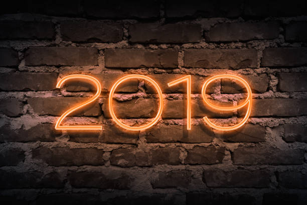 istock Upcoming 2019 year as neon sign on brickwall pattern as backgound 914779628