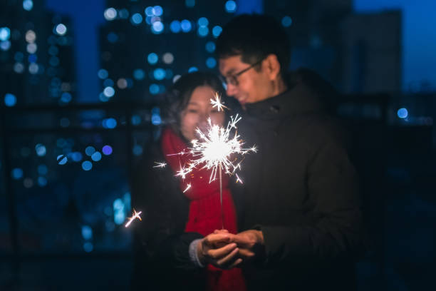 istock Couple holding sparklers at night 914779906