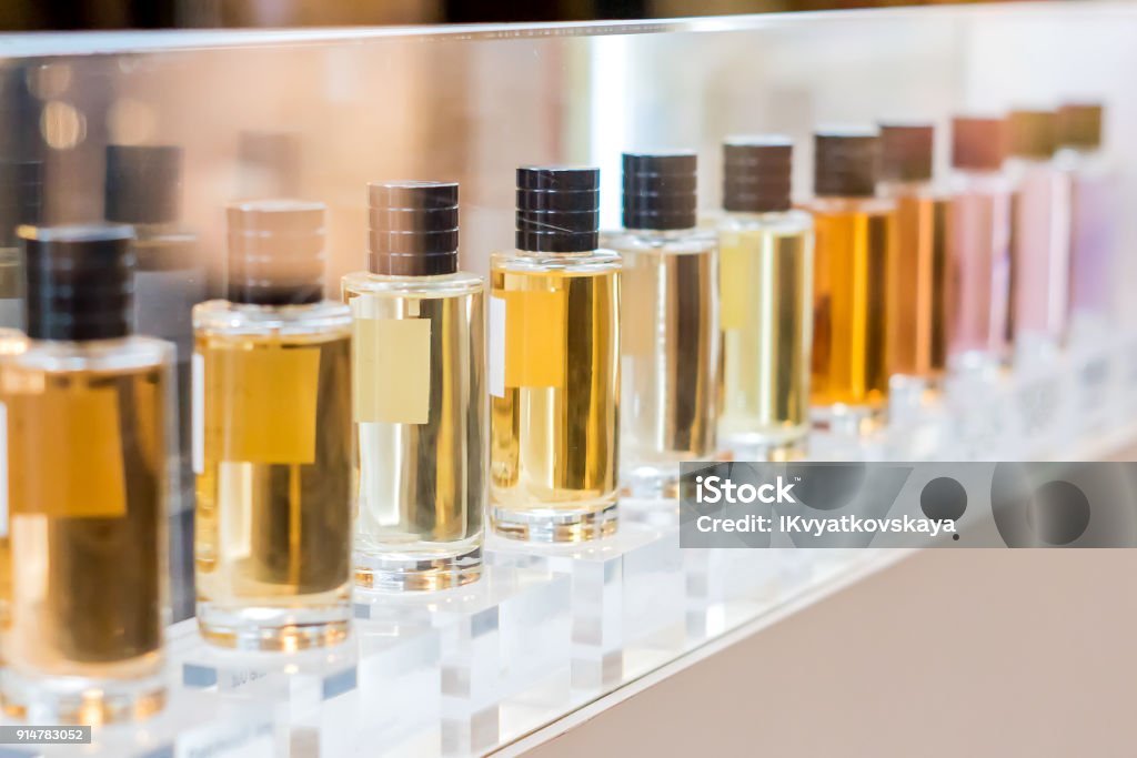 set of colorful perfume bottles in shop window set of colorful perfume bottles in shop window. Perfume Stock Photo