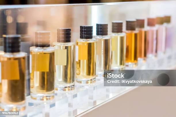 Set Of Colorful Perfume Bottles In Shop Window Stock Photo - Download Image Now - Perfume, Scented, Luxury