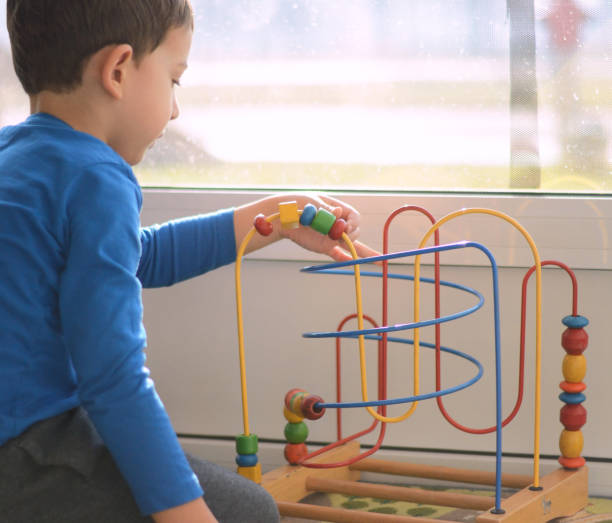 istock Cute little boy is playing with educational toys 914783480