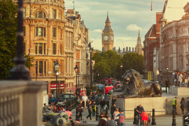 people visiting trafalgar square in london with the big ben in the background - city of westminster big ben london england whitehall street imagens e fotografias de stock