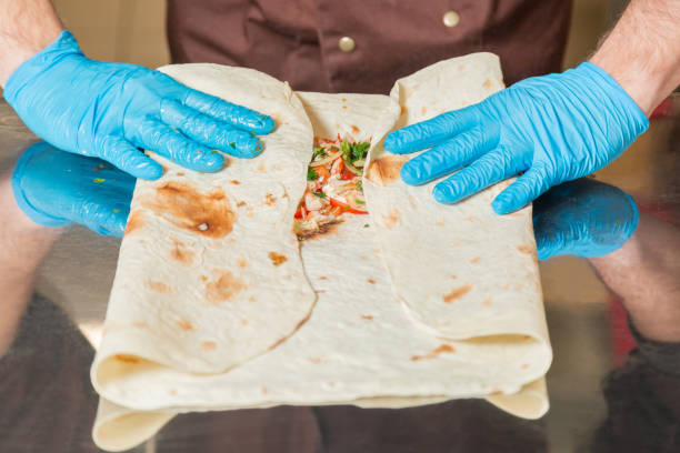 istock Cooking Shawarma. The ingredients are wrapped in pita bread. 914787550