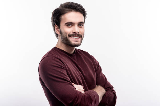 istock Charming young man folding his arms and posing 914789112