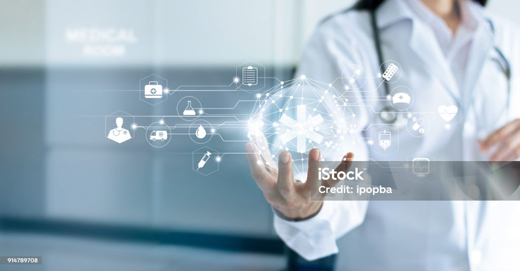 Technology Innovation and medicine concept. Doctor and medical network connection with modern virtual screen interface in hand on hospital background Healthcare And Medicine Stock Photo