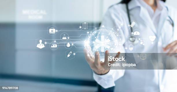 Technology Innovation And Medicine Concept Doctor And Medical Network Connection With Modern Virtual Screen Interface In Hand On Hospital Background Stock Photo - Download Image Now