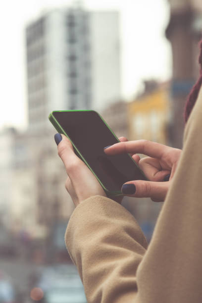 istock Girl using cellphone while crossing the big street. 914791862