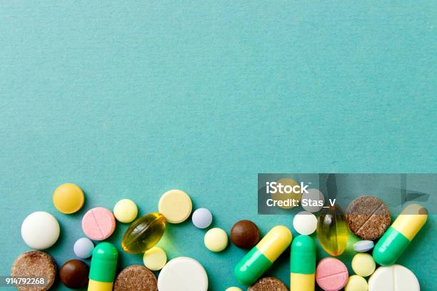 Many Colorful Pills On Red Background With Copy Space Pattern Identification Of Pills Stock Photo - Download Image Now