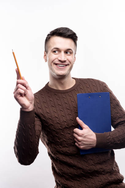 istock Upbeat man posing with pencil and sheet holder 914793202
