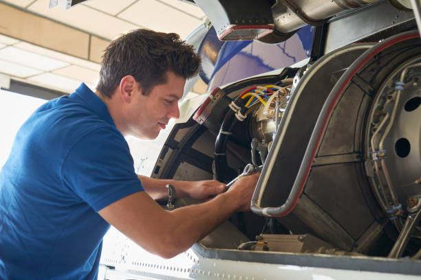 istock Male Aero Engineer Working On Helicopter In Hangar 914793566