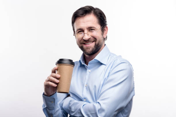 istock Charming middle-aged man in eyeglasses posing with coffee cup 914796014