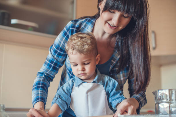 istock mother and son cooking in kitchen and looking down 914800214
