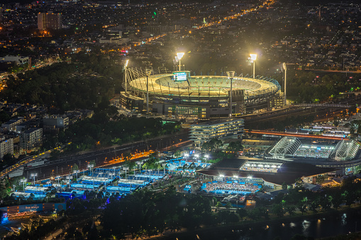 Melbourne, Australia - January 16, 2018: aerial view of Yarra Park, illuminated for the Australian Open and the MCG for a one day cricket international.