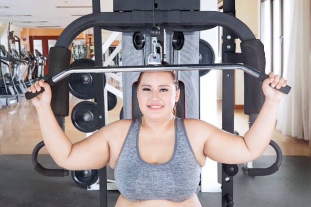 istock Happy fat woman exercising her biceps 914801518