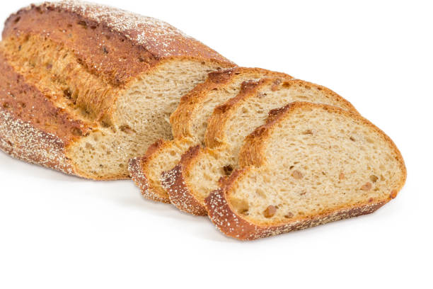 istock Partly sliced brown bread with whole sprouted wheat grains closeup 914801580