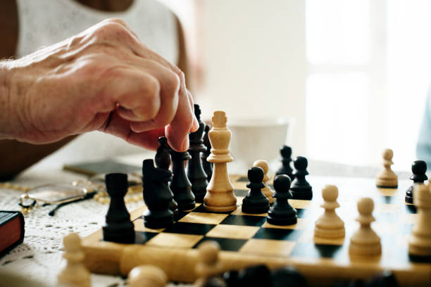 istock Senior friends playing chess together 914802324