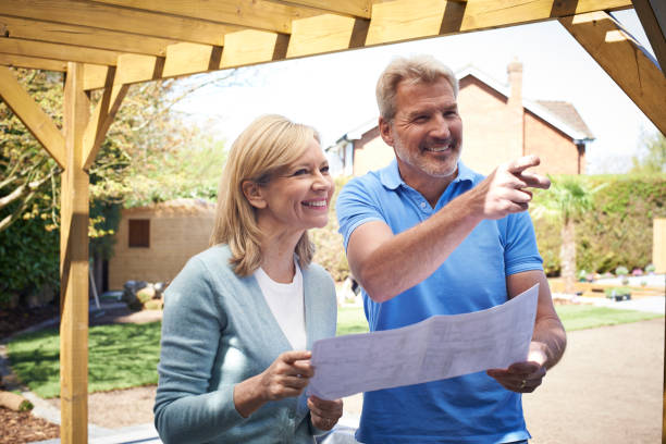 istock Mature Woman Discusses Plan With Landscape Gardener 914807380
