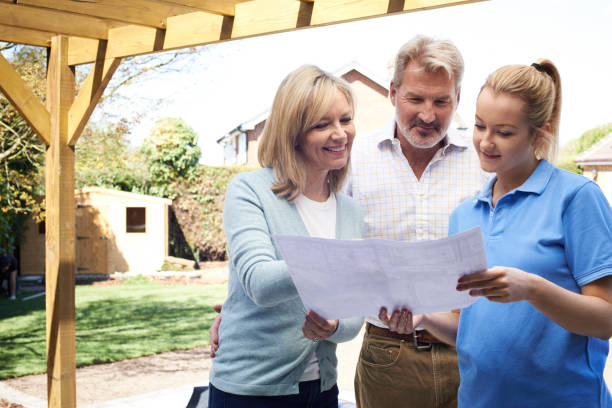 istock Mature Couple Discussing Plan With Landscape Gardener 914809694