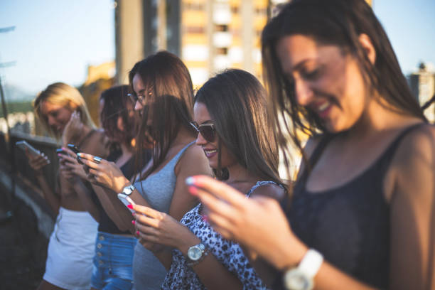 istock Ladies in a row using smartphones 914810304