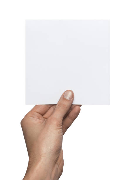 istock Mockup square empty blank white postcard holds the man in his hand. Isolated on a white background 914810324