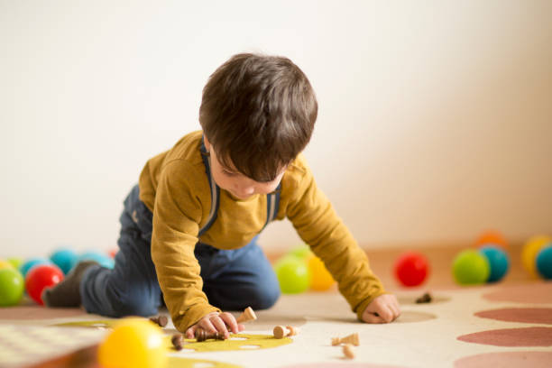 istock Baby boy playing with toy ball 914810350