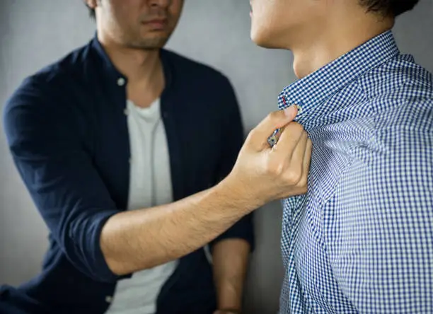 Man grab other by the collar, having argument
