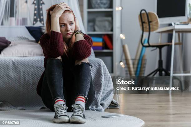 Worried Girl Holding Head Stock Photo - Download Image Now - Teenager, Adolescence, Depression - Sadness