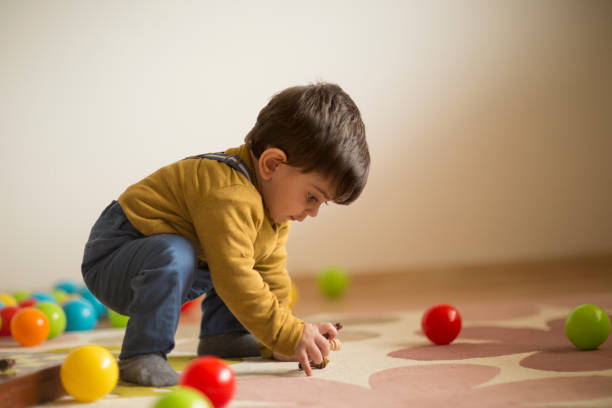 istock Baby boy playing with toy ball 914810822