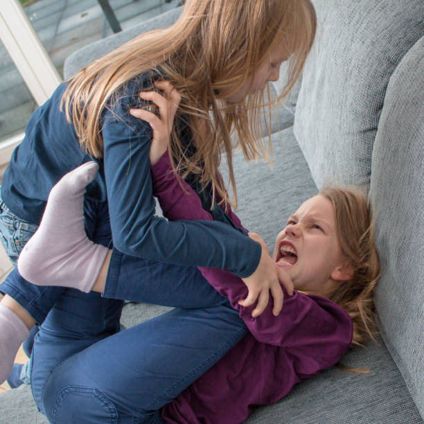 A 7- and a 9-year-old girl yell at each other and beat each other A 7- and a 9-year-old girl scream at each other and beat each other charging sports photos stock pictures, royalty-free photos & images