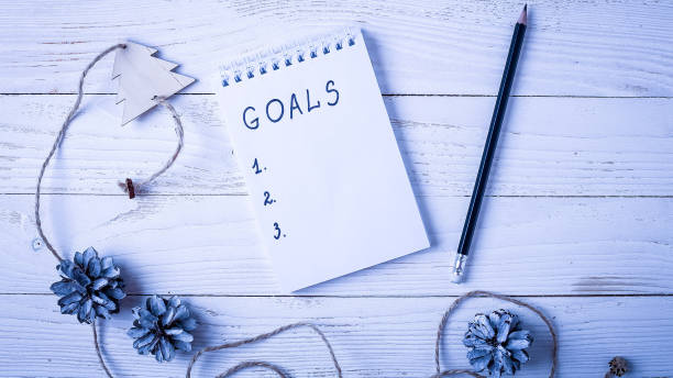 istock Workplace with a diary, decorations and gifts. New Year's list o 914819046