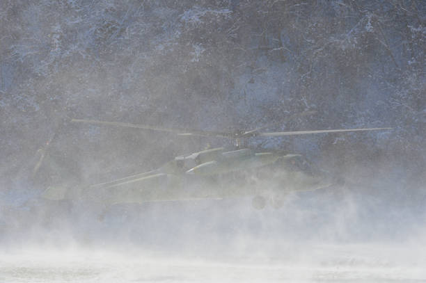 istock Military Helicopter landing in winter snow. 914819470