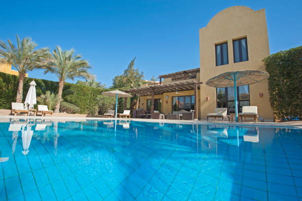 istock Swimming pool at a luxury tropical holiday villa 914819476