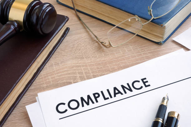 istock Compliance on a wooden desk with books. 914821858