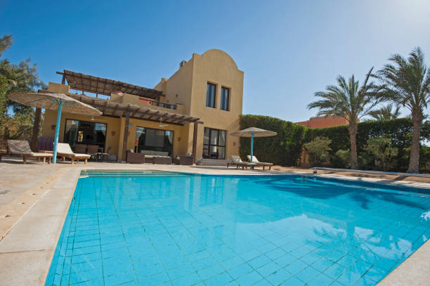 istock Swimming pool at a luxury tropical holiday villa 914822090