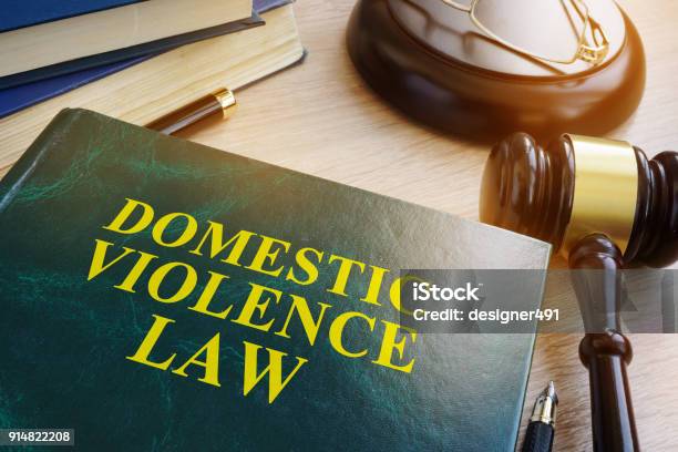 Domestic Violence Law On A Wooden Table Stock Photo - Download Image Now - Domestic Violence, Law, Lawyer