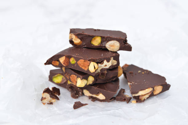 istock Dark chocolate bark with mixed nuts on wax paper 914823730