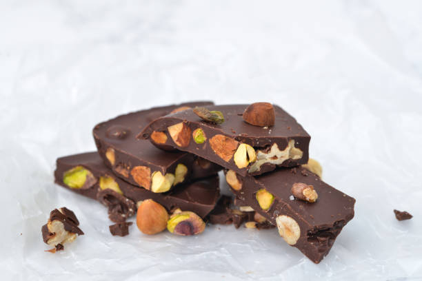 istock Dark chocolate bark with mixed nuts on wax paper 914823744