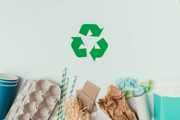 istock flat lay with various types of garbage and recycle sign isolated on grey 914826072