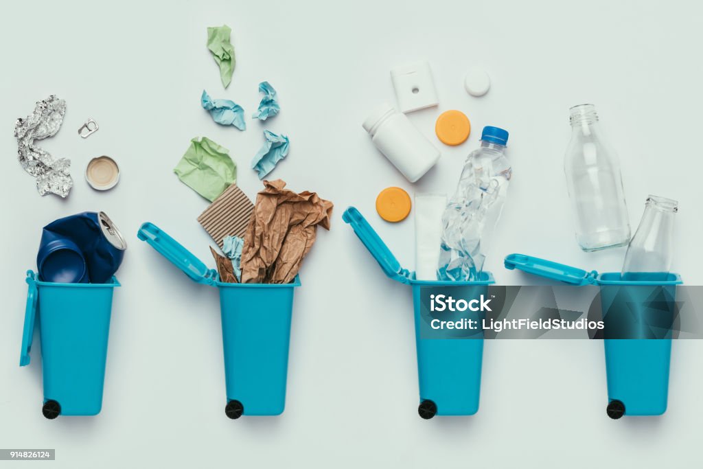 top view of trash bins and assorted garbage isolated on grey, recycle concept Garbage Stock Photo