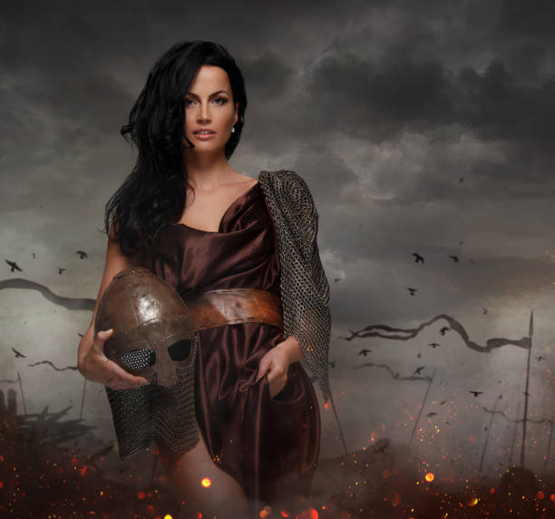 istock Attractive war queen holding helmet in fire sparks. 914826812
