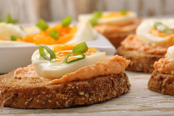 Sandwiches with salmon paste Sandwiches with salmon paste and egg on white wooden background"n"n tuna pate stock pictures, royalty-free photos & images