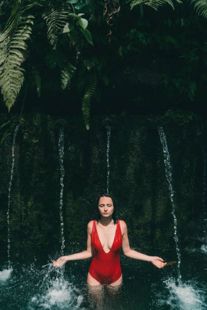 istock Woman standing in spring pool in Bali 914827228