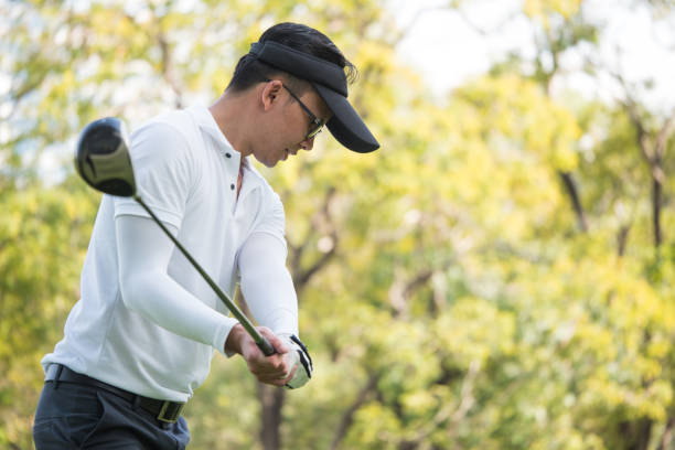 istock Asian man golf player swinging driver golf club on golf course. 914829990