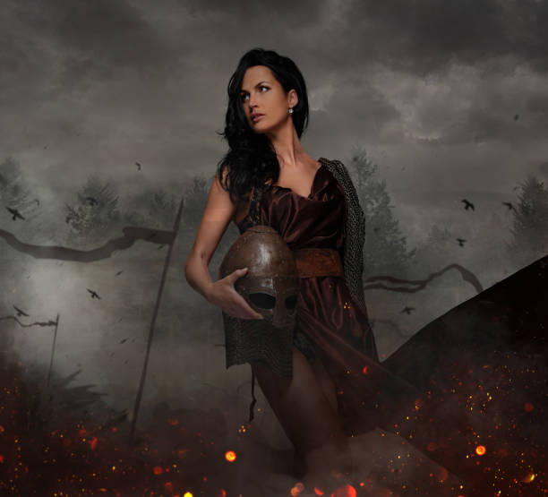 istock Attractive war queen holding helmet in fire sparks. 914830224