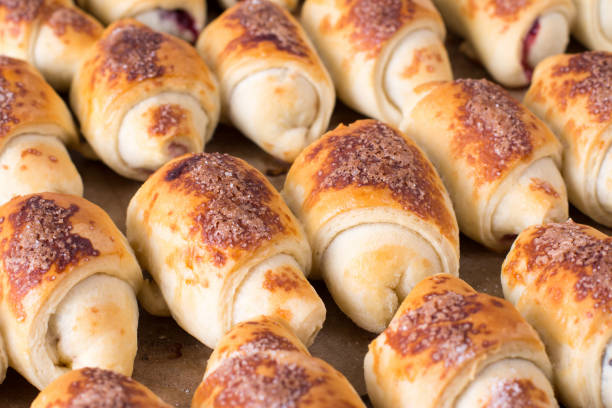 istock Small sweet homemade croissants in the kitchen on a baking sheet 914830516