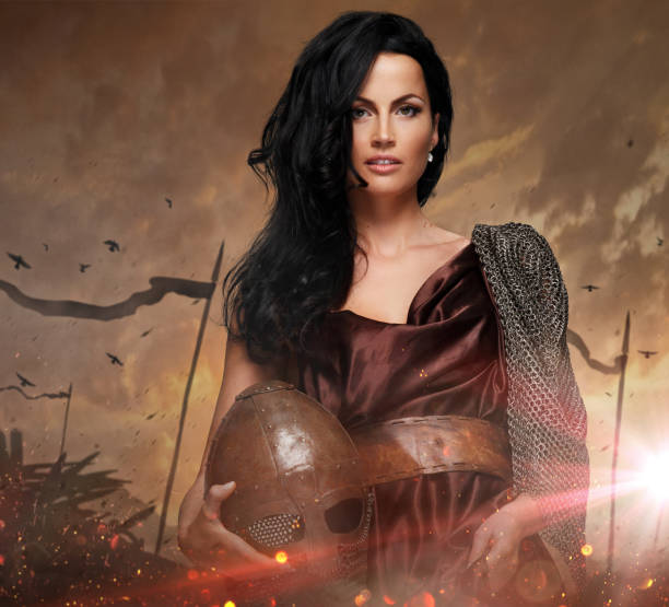 istock Attractive war queen holding helmet in fire sparks. 914830712
