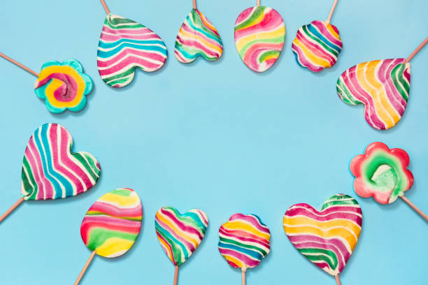 istock Set of rainbow colorful candy isolated on blue background. Top view. 914830776