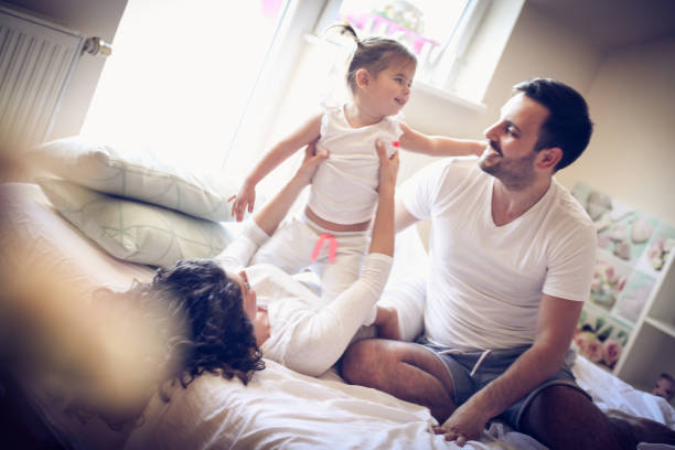 istock Playing wit parents at morning. Little girl. 914833272