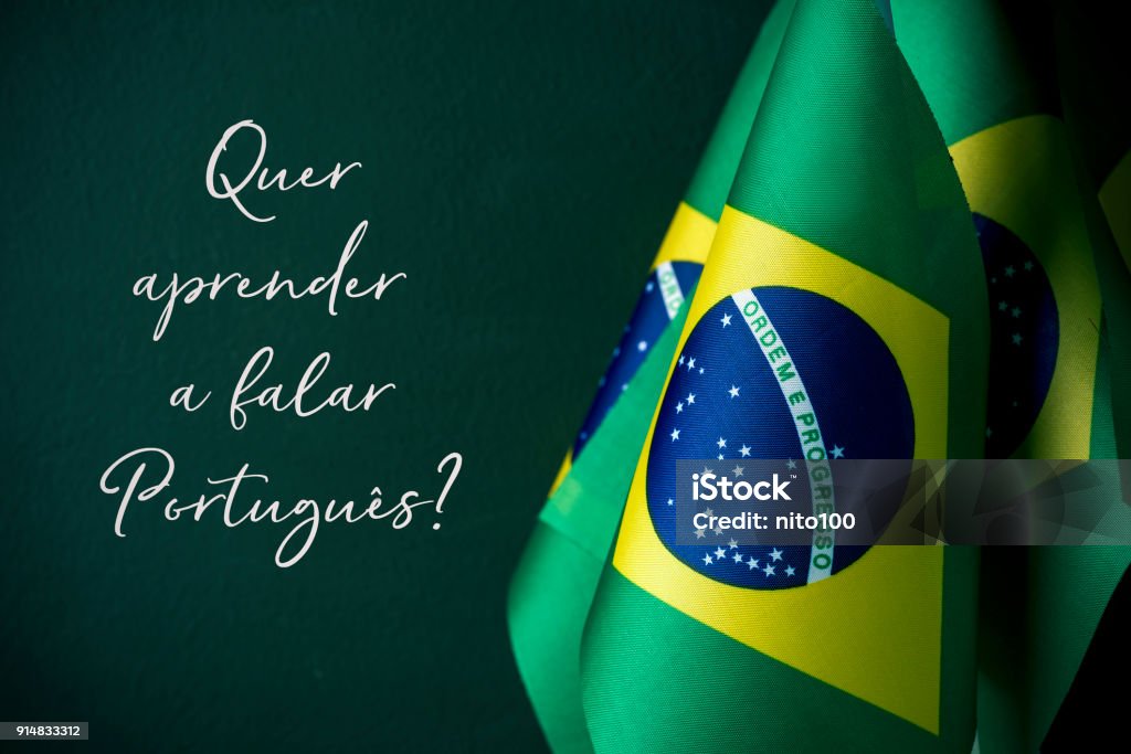 do you want to learn portuguese, in portuguese some flags of brazil and the question quer aprender a falar portugues?, do you want to learn to speak portuguese? written in portuguese, against a dark green background Brazil Stock Photo