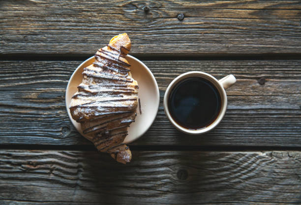 istock Coffee cup with croissant for breakfast. Food, morning, snack 914833422